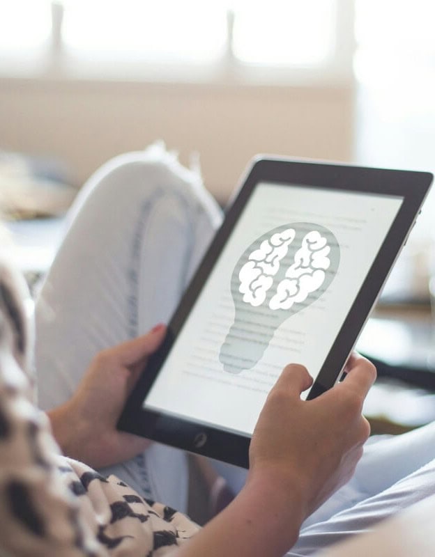 brain training on a tablet held in a woman's hand